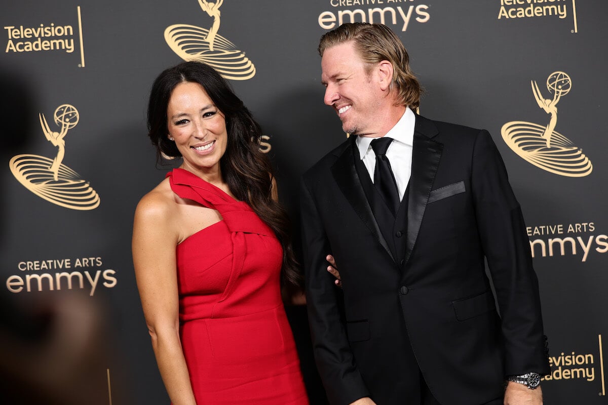 "Fixer Upper" stars Joanna and Chip Gaines smile and pose together at an event.