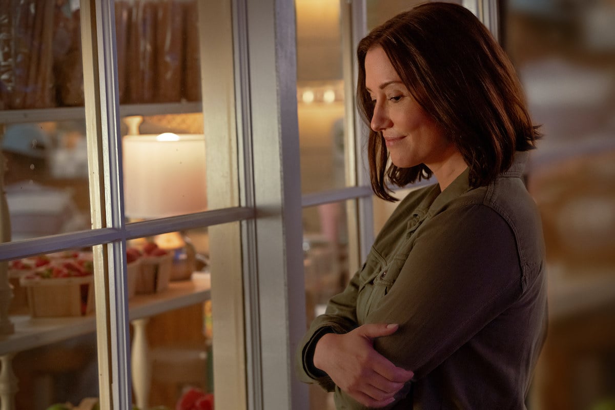 Chyler Leigh looking through a window in the Hallmark Channel series 'The Way Home'