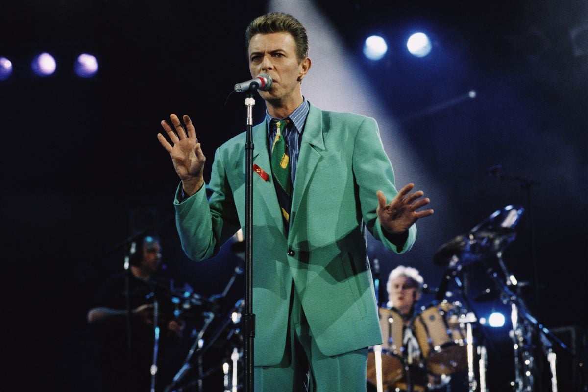 David Bowie sings into a microphone