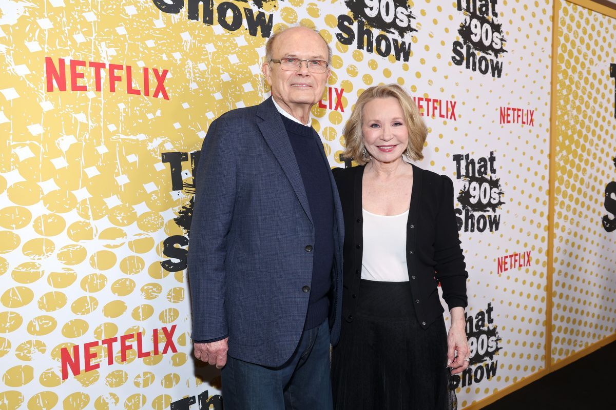 Kurtwood Smith and Debra Jo Rupp pose for photos in front of a yellow and white backdrop.