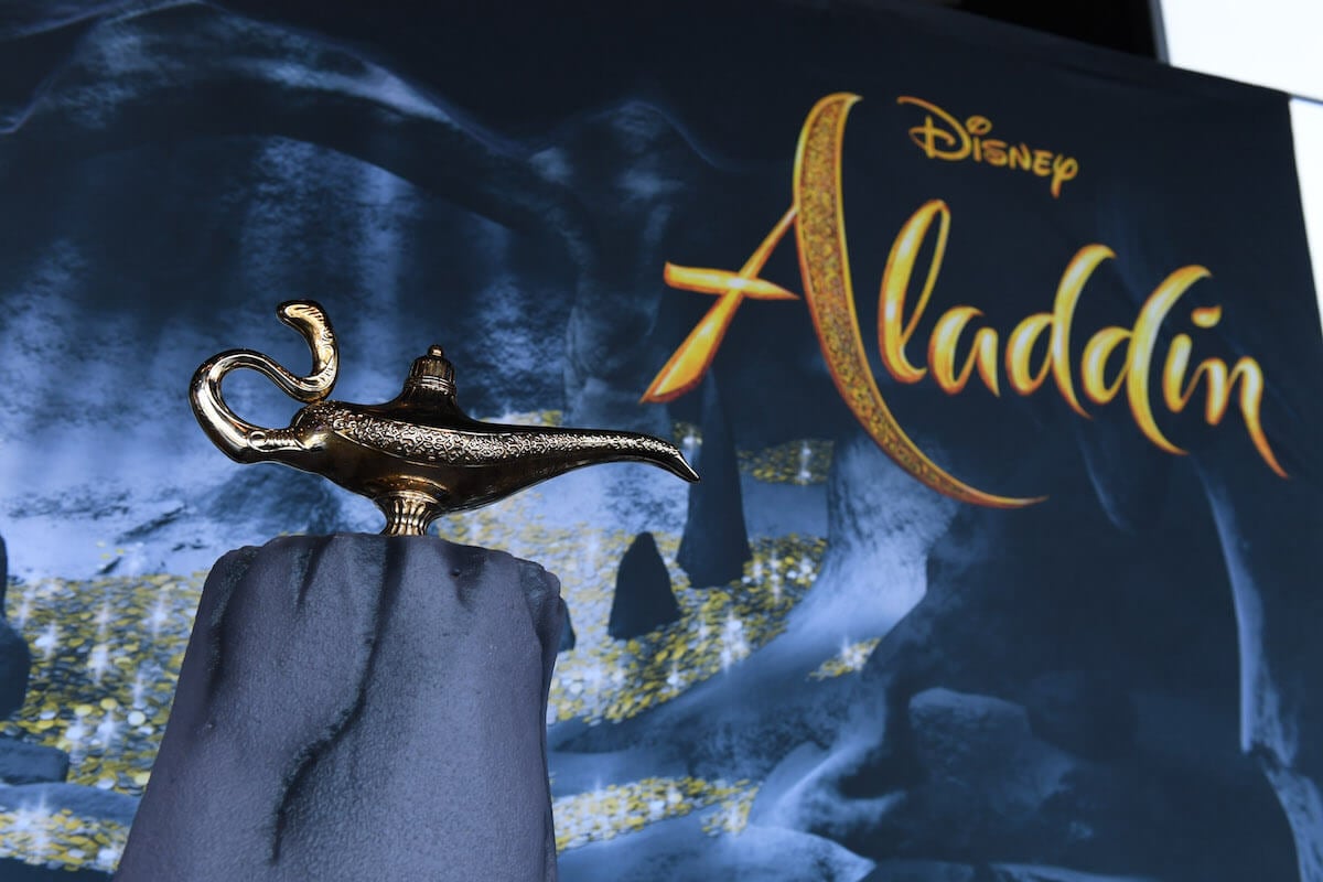 A Genie lab on a table in front of a Disney Aladdin sign