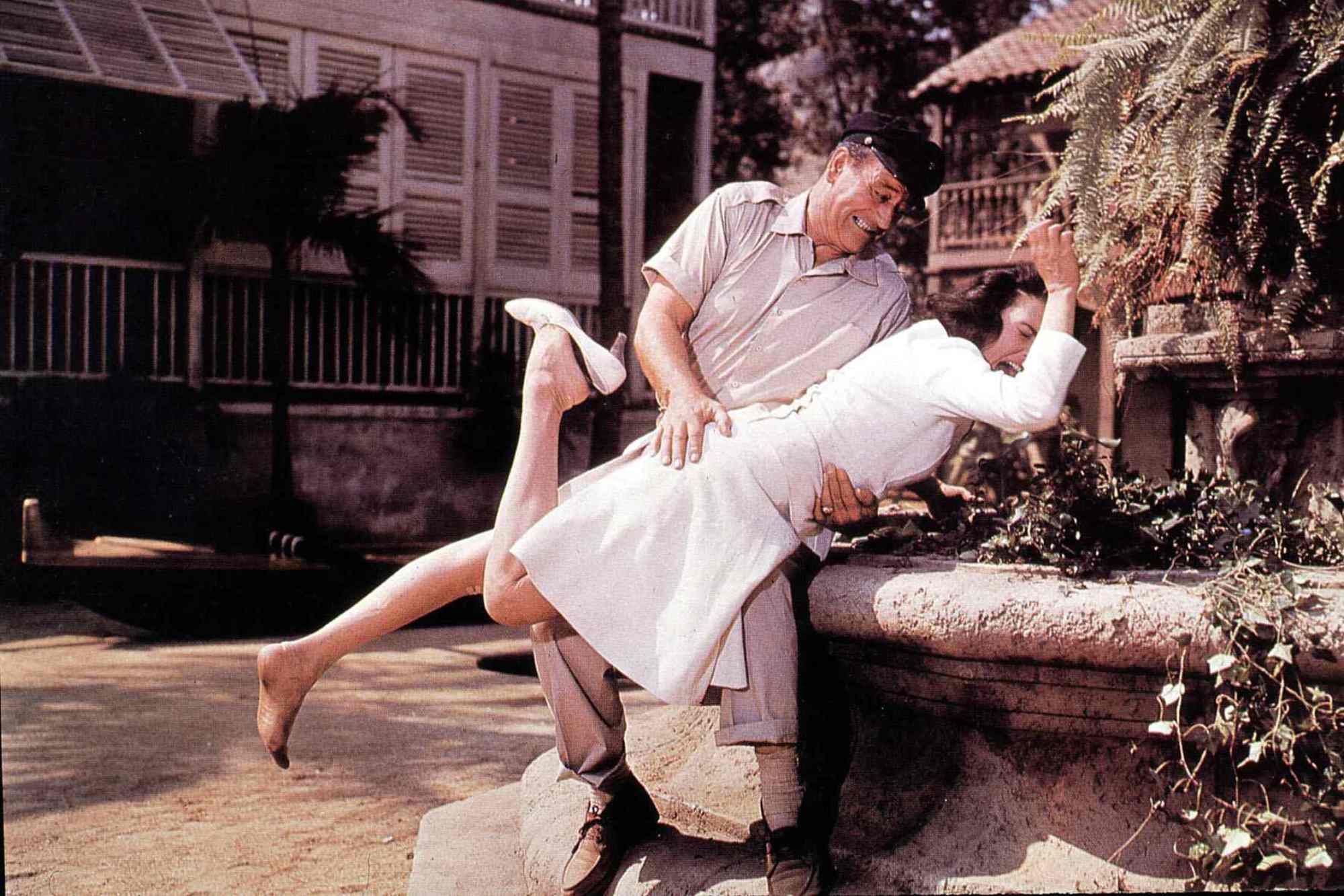 'Donovan's Reef' John Wayne as Michael Patrick 'Guns' Donovan and Elizabeth Allen as Amelia Dedham. Wayne has Allen bent over his knee, spanking her.