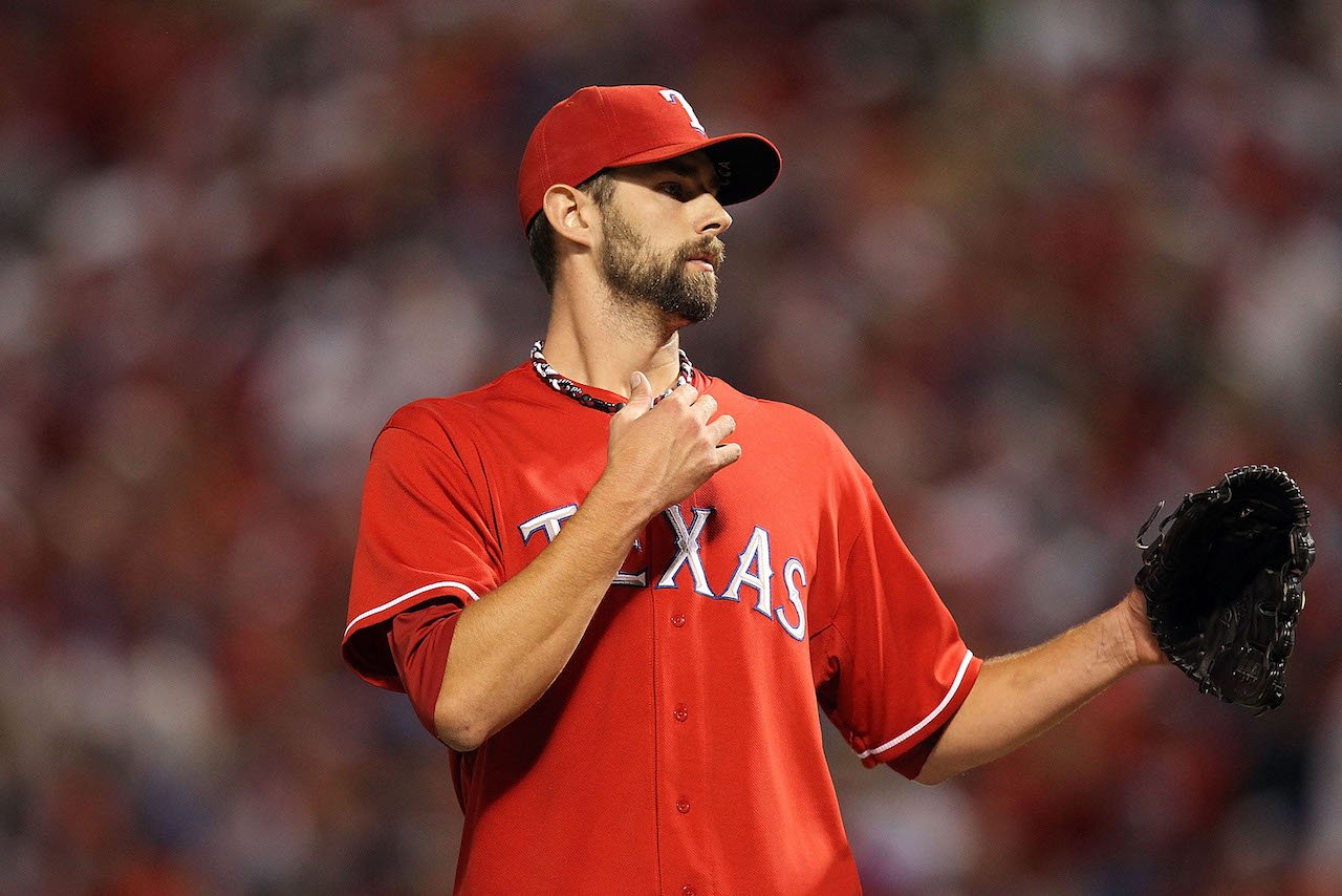 Dustin Nippert stands on the pitcher mound in a red Texas jersey.