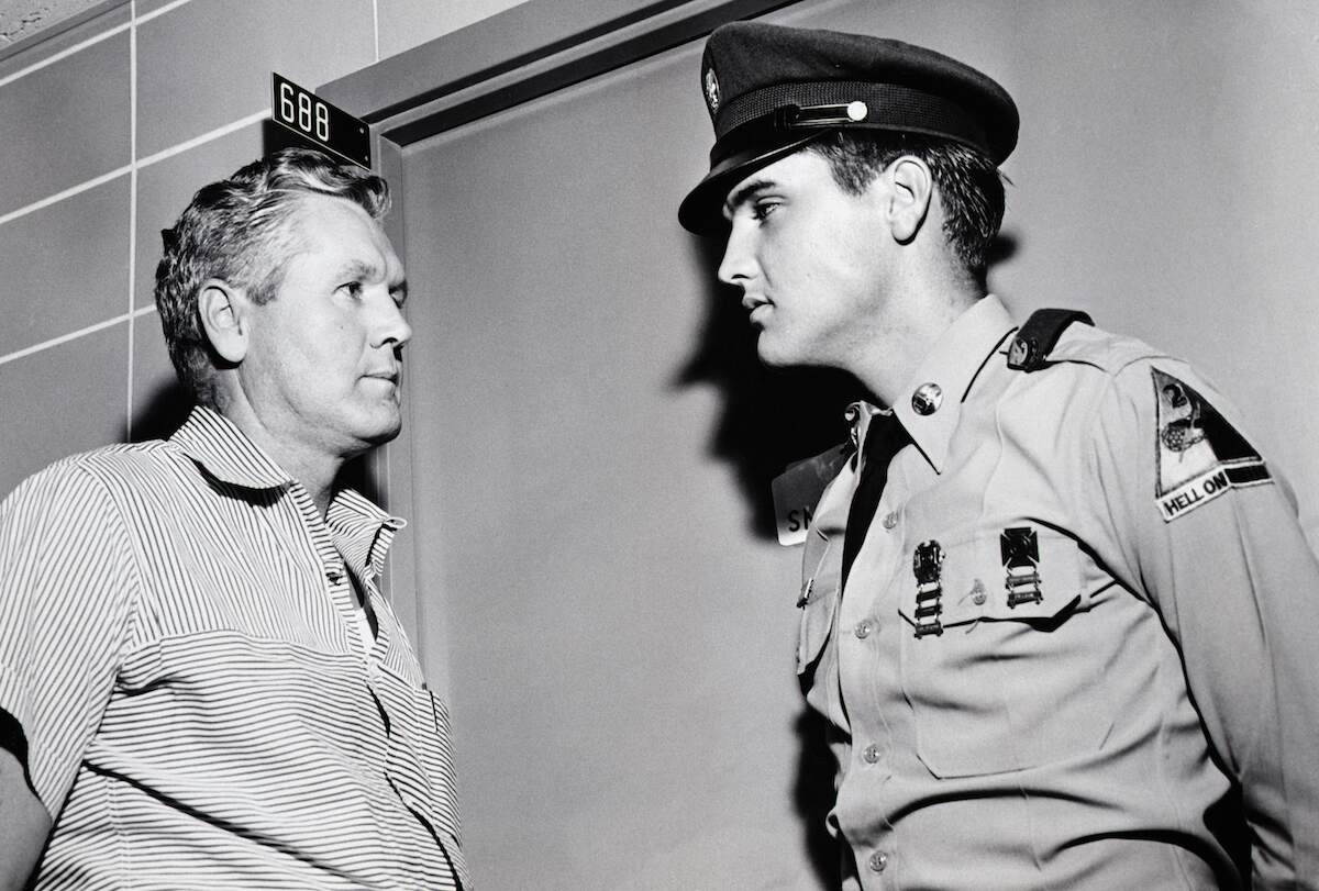 Elvis Presley and his father, Vernon Presley, discuss the illness of Presley's mother outside her hospital room in 1958