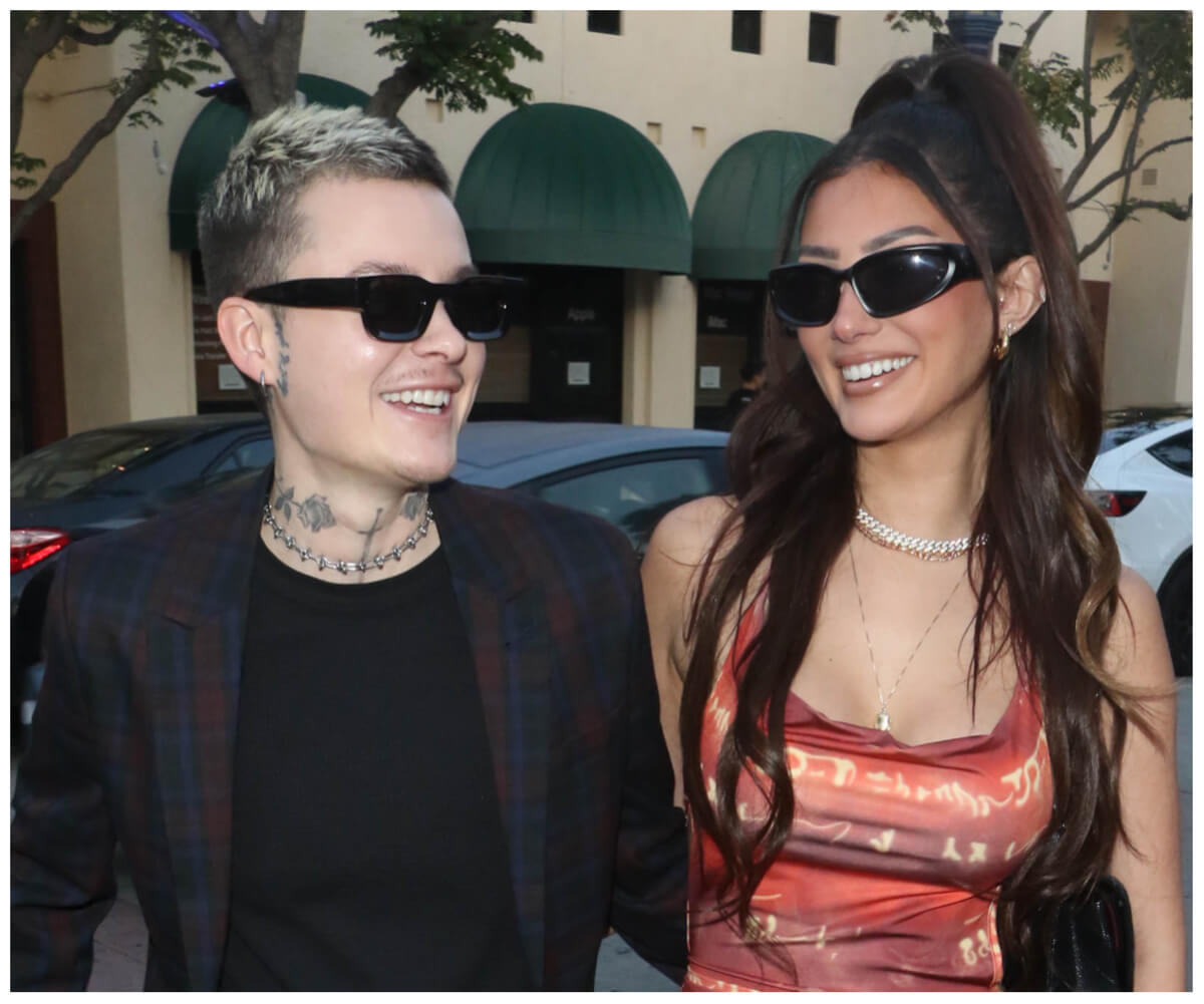 Francesca Farago and her boyfriend, Jesse Sullivan, smile together wearing sunglasses.