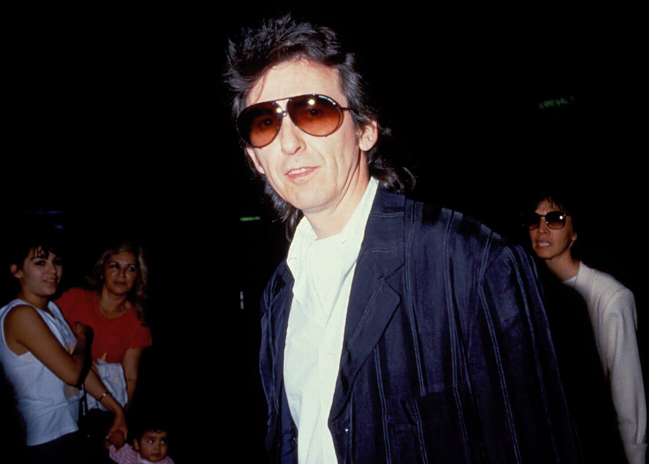 George Harrison in a black suit at LAX Airport in 1988.