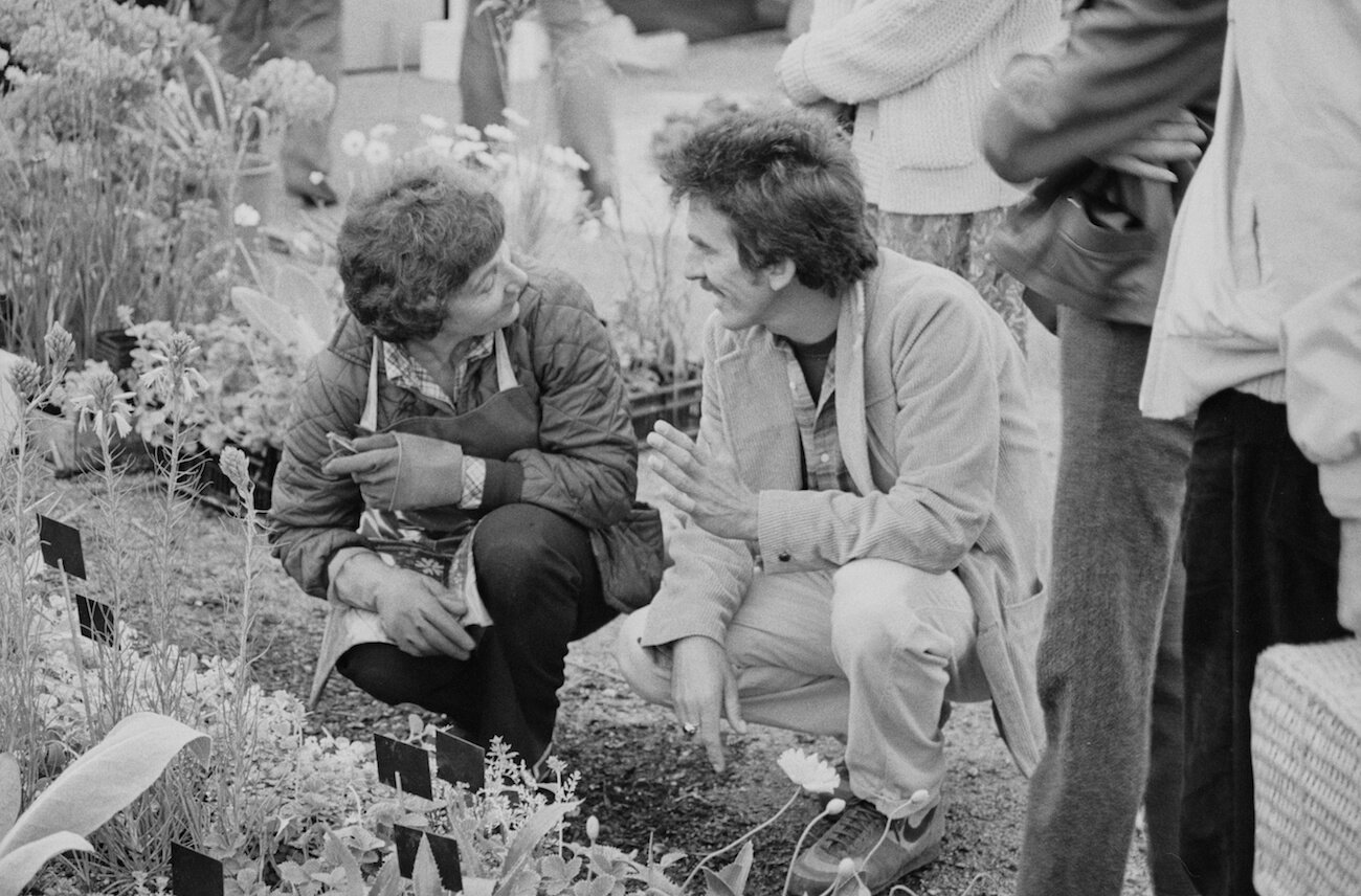 George Harrison talking to someone at the Chelsea Flower Show in 1984.