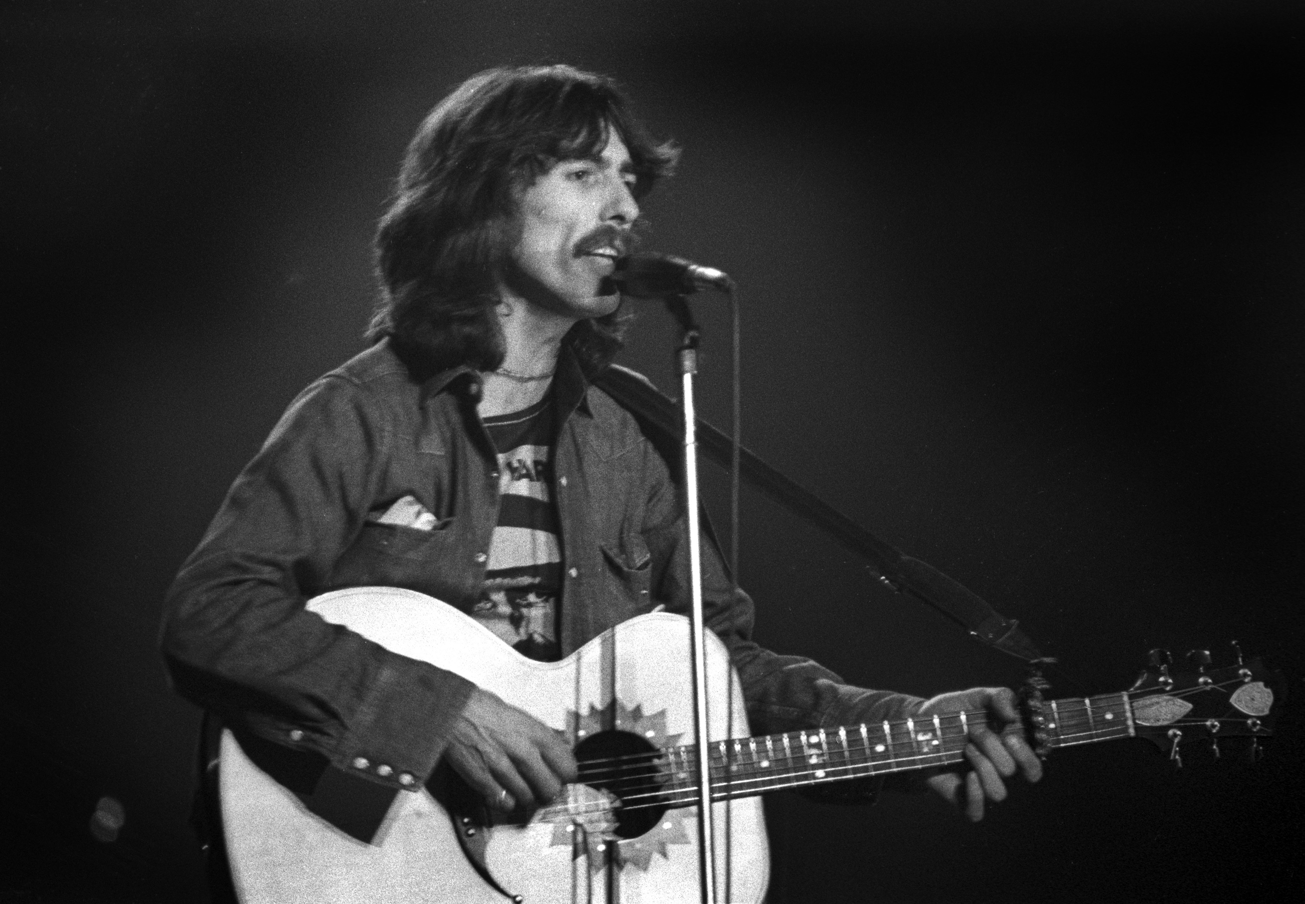 Former member of The Beatles George Harrison performs at Olympia Stadium in Detroit, Michigan