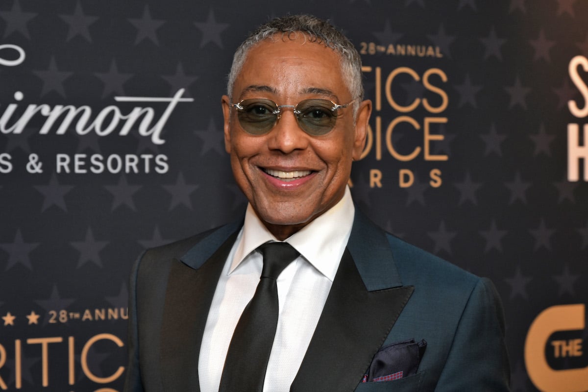 Giancarlo Esposito poses in front of a black backdrop.