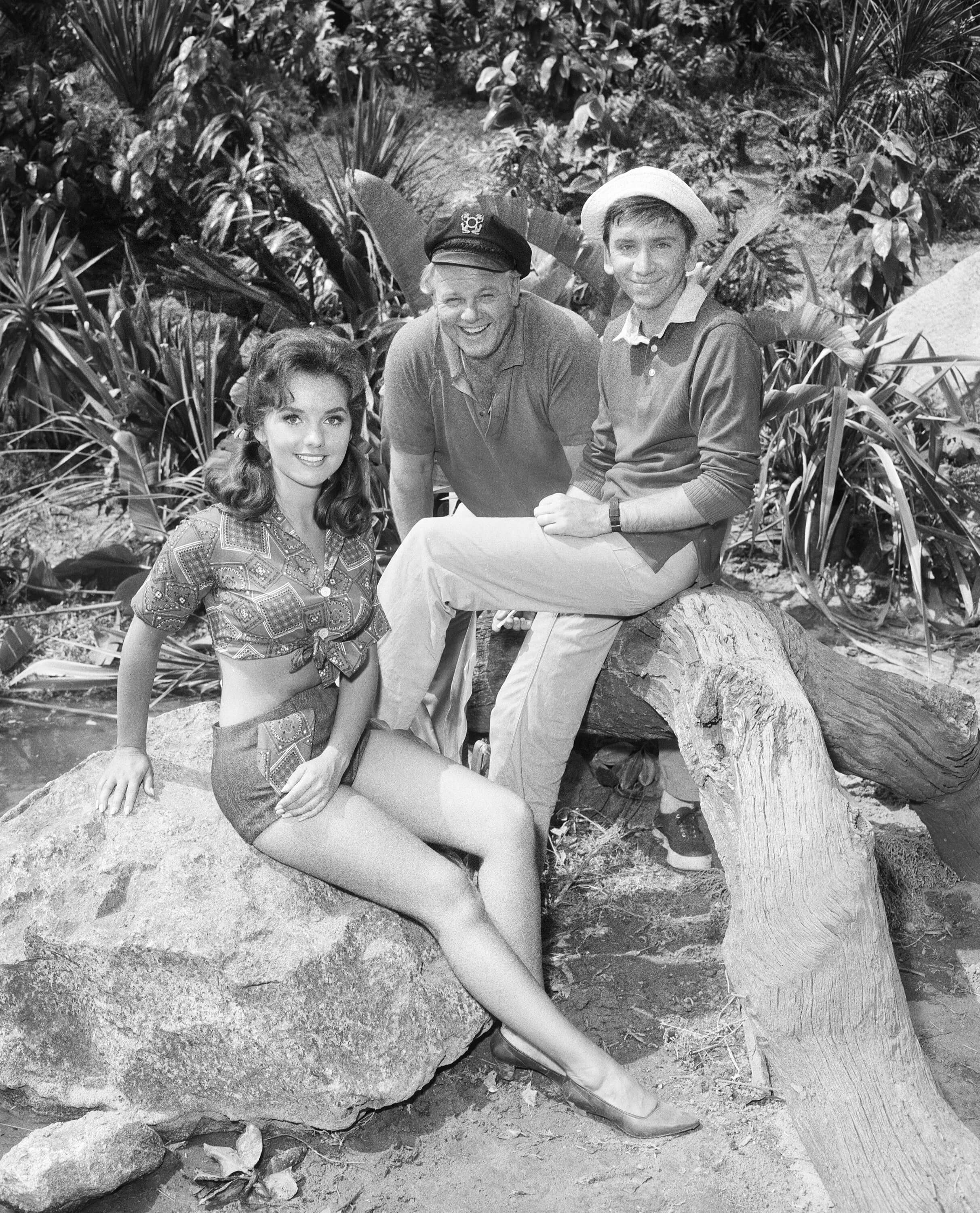 'Gilligan's Island' cast members Dawn Wells, Alan Hale Jr, and Bob Denver posing in a black and white photo for the show.