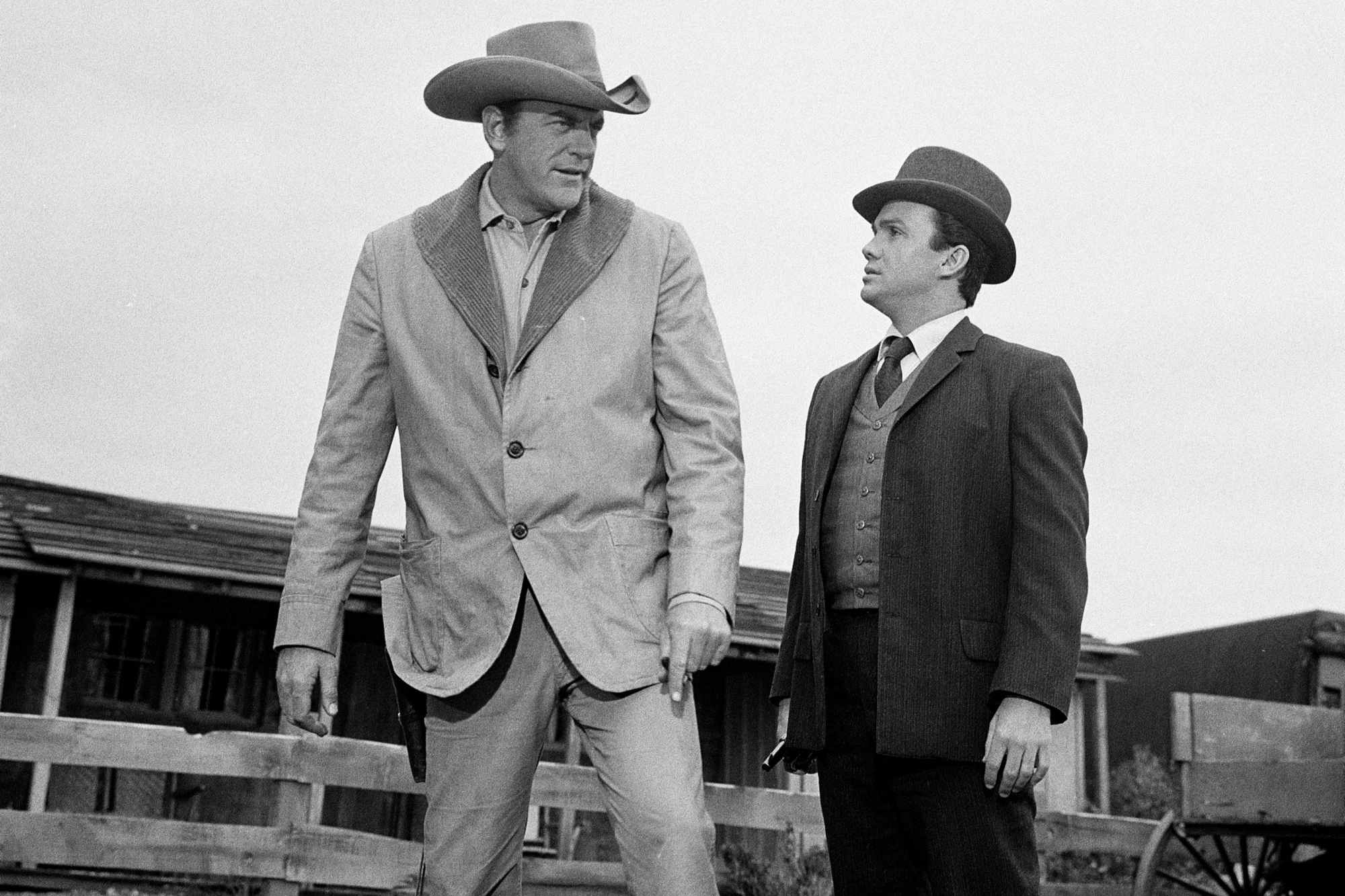 'Gunsmoke' Easter egg Western. James Arness as Matt Dillon and Ben Cooper as Breck Taylor. Arness and Cooper are looking at each other, wearing Western costumes.