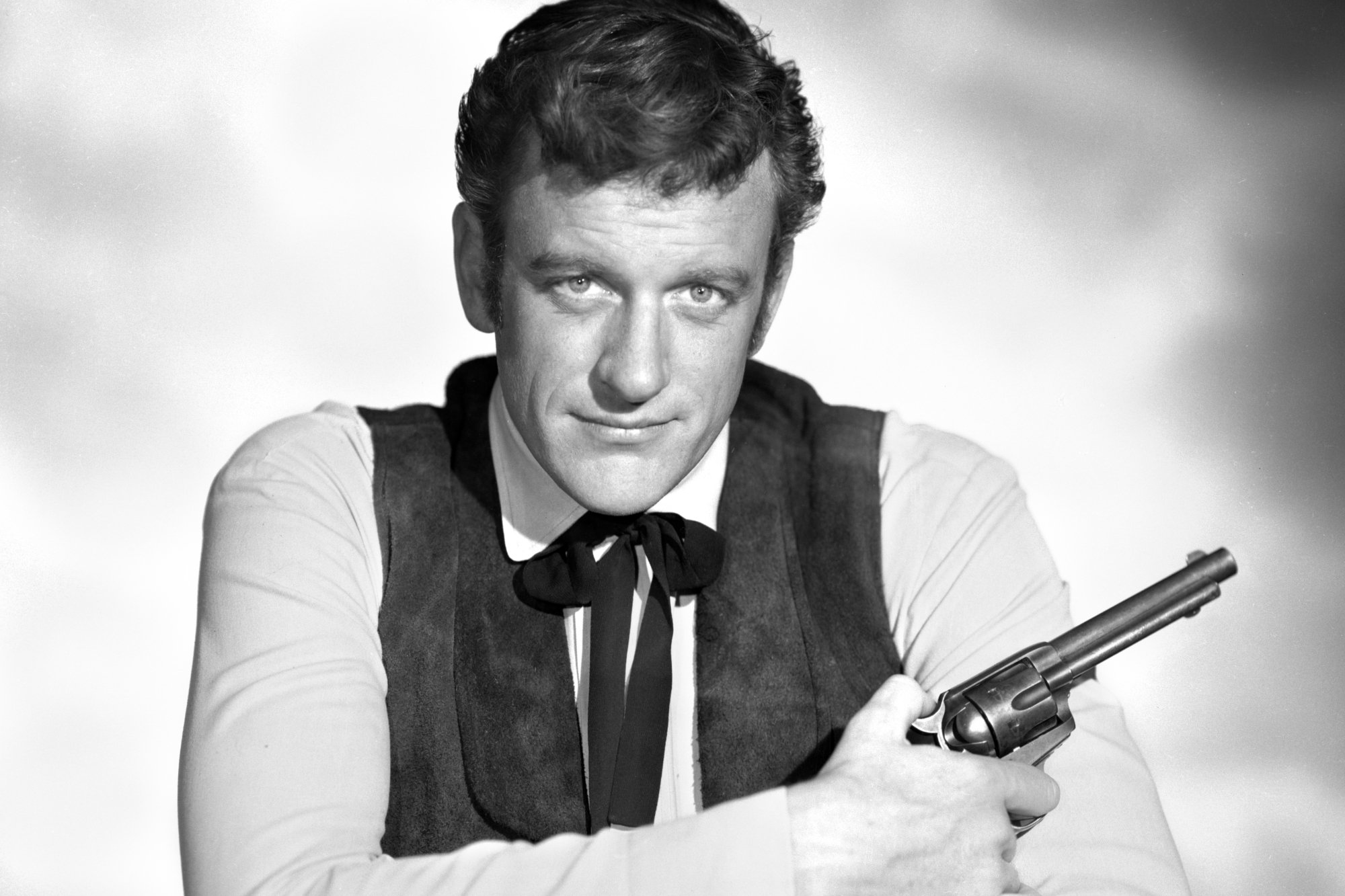 'Gunsmoke' James Arness as Matt Dillon holding a gun in a black-and-white portrait shot