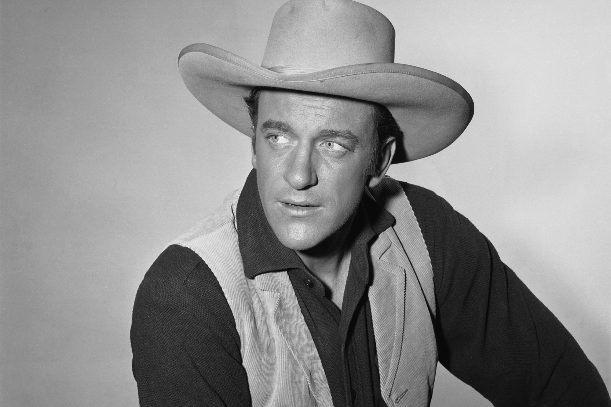 'Gunsmoke' James Arness as U.S. Marshal Matt Dillon looking off to the side, wearing his cowboy costume.