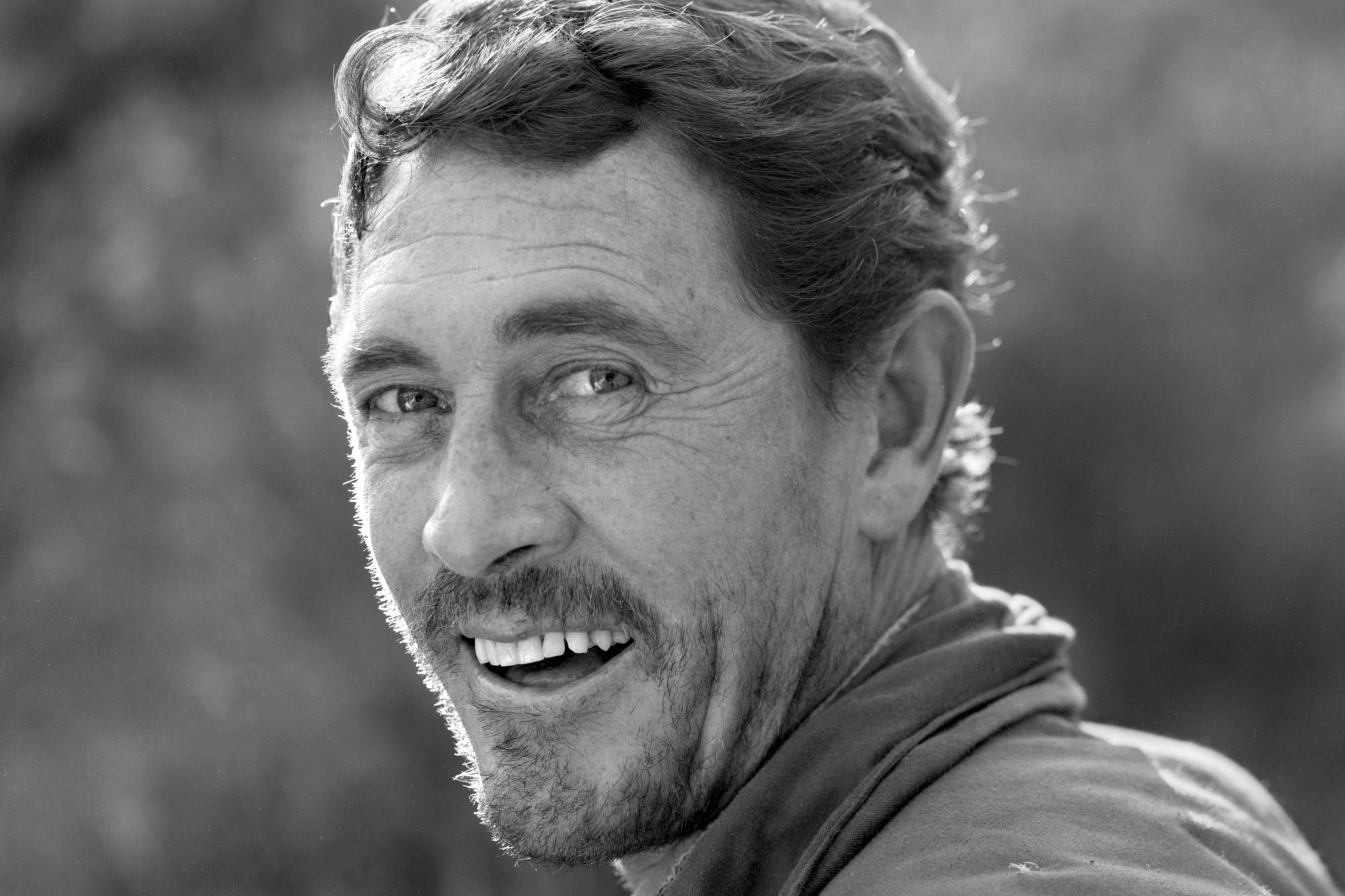 'Gunsmoke' Ken Curtis as Festus Haggen smiling in a black-and-white portrait shot