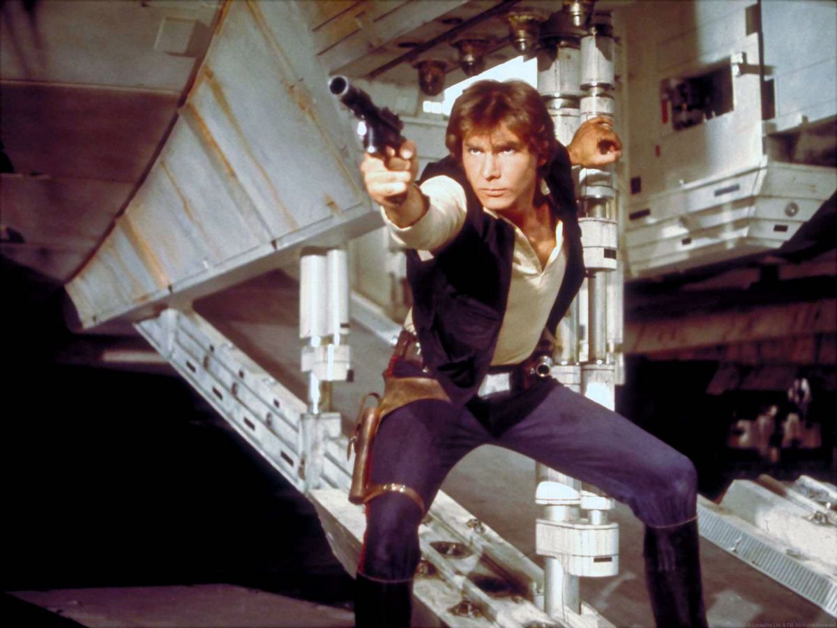 American actor Harrison Ford, as Hans Solo, brandishes his gun on the set of Star Wars: Episode IV - A New Hope