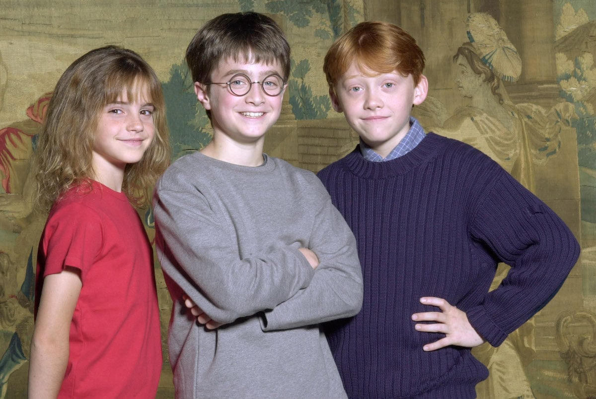 Daniel Radcliffe, Emma Watson, and Rupert Grint pose for their first first photos together after being chosen for Harry Potter