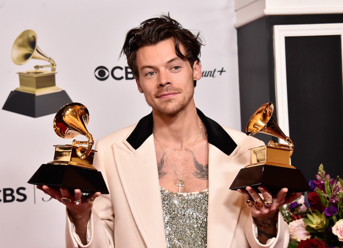 Harry Styles holds two trophies at the 2023 Grammy Awards.