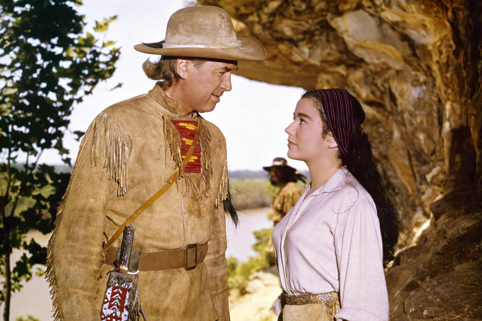 'How the West Was Won' James Stewart as Linus Rawlings and Brigid Bazlen as Dora Hawkins wearing Western costumes looking at one another over a rock overhang
