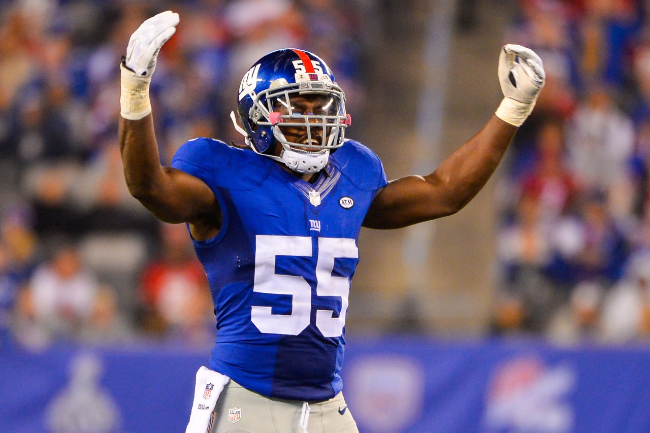 J.T. Thomas III raises his arms during a game with the NY Giants.
