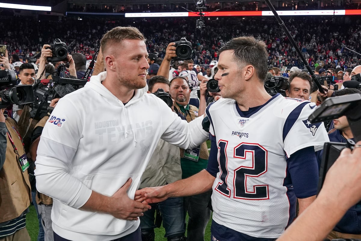 JJ Watt and Tom Brady shake hands at a football game.