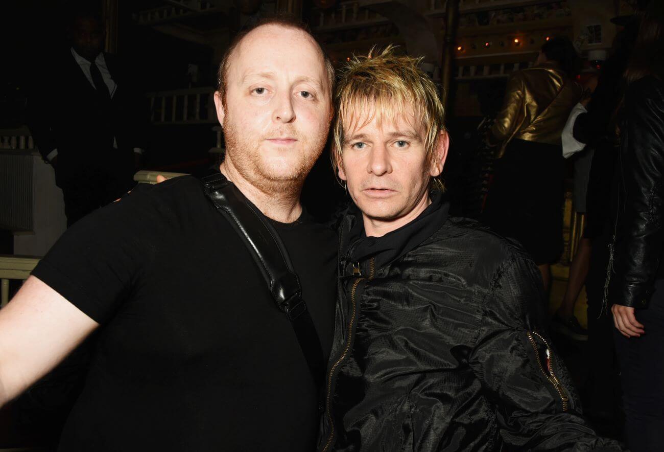 James McCartney and Zak Starkey wear black and pose together.