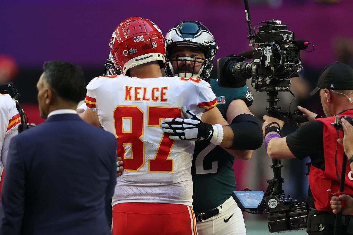 Travis Kelce #87 of the Kansas City Chiefs hugs Jason Kelce #62 of the Philadelphia Eagles before Super Bowl LVII at State Farm Stadium on February 12, 2023 in Glendale, Arizona