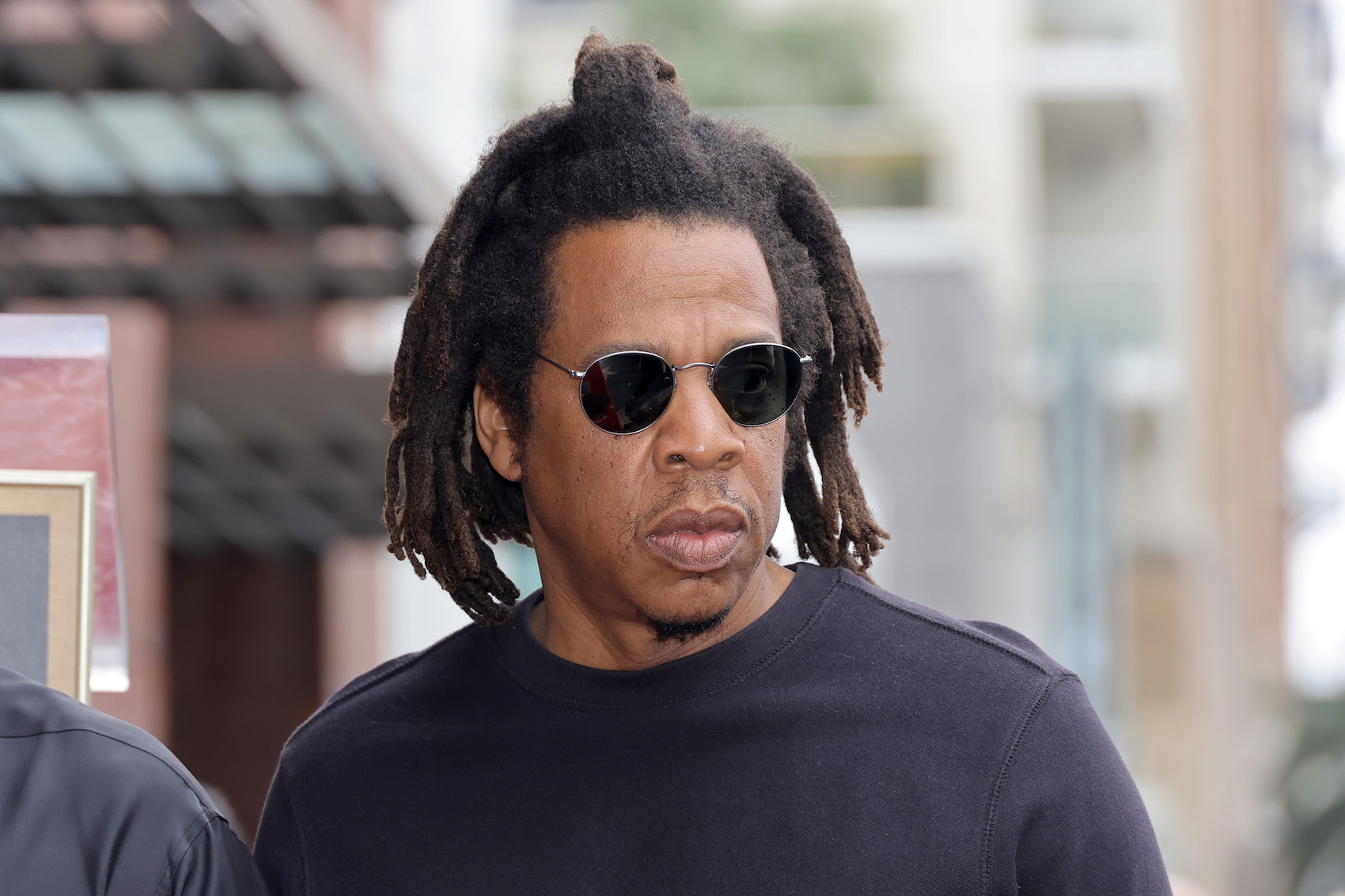 Jay-Z wearing a black shirt and sunglasses