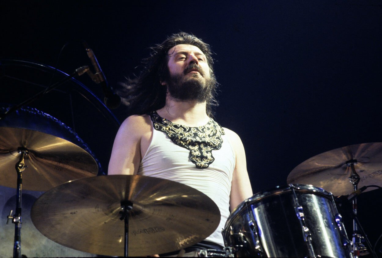 Led Zeppelin drummer John Bonahm sits behind his kit during a 1977 concert.