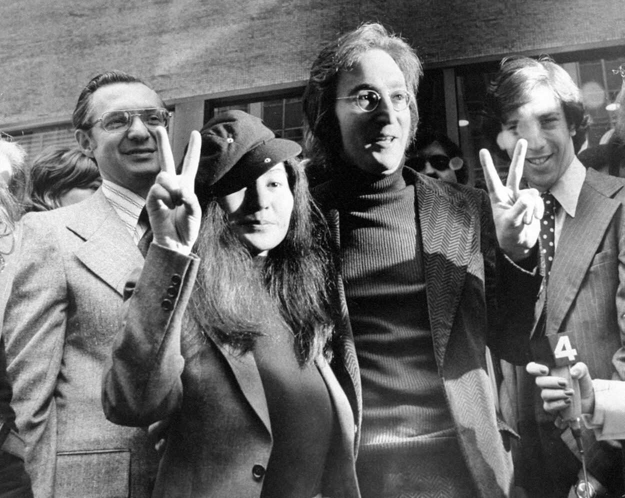 John Lennon (center right) stands next to Yoko Ono as they leave the Immigration and Naturalization Service in New York City in April 1972.