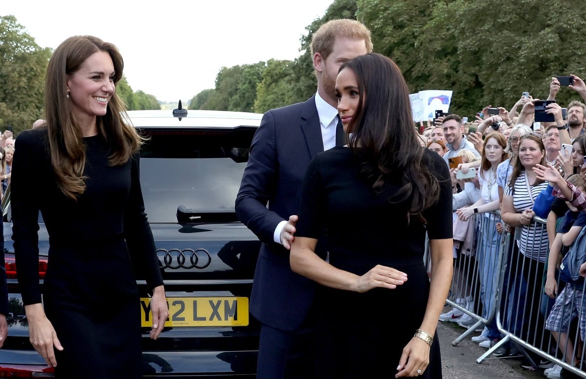 Kate Middleton, Meghan Markle, and Prince Harry on the long Walk at Windsor Castle after viewing flowers and tributes to Queen Elizabeth