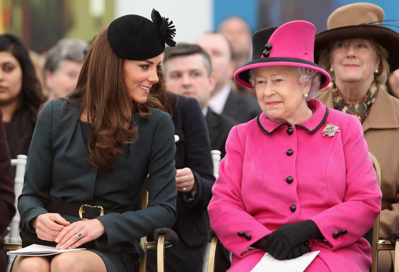 Kate Middleton, Princess of Wales, and Queen Elizabeth II sit together during a royal engagement.