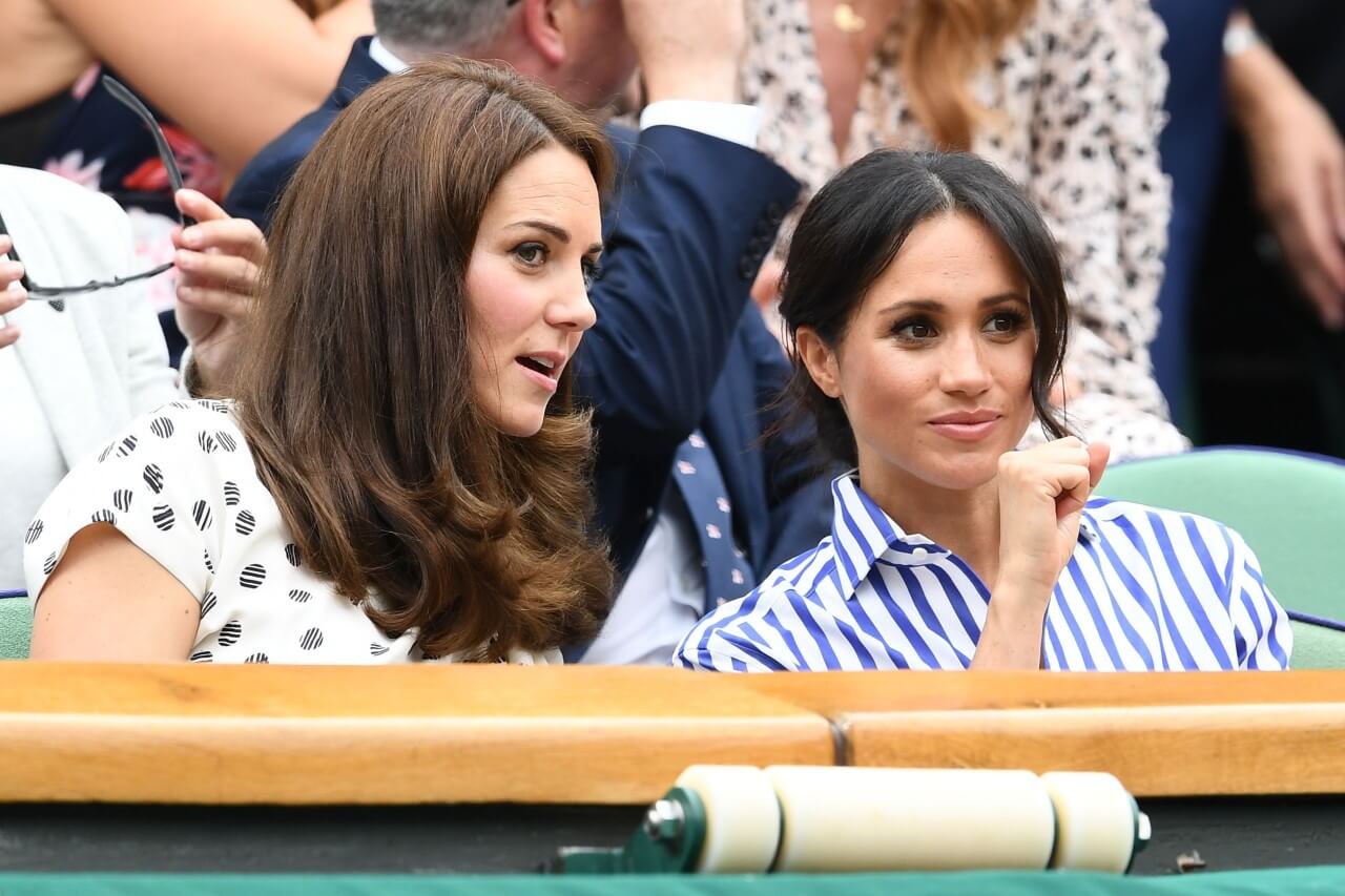 Kate Middleton and Meghan Markle chat during Wimbelton 2018.