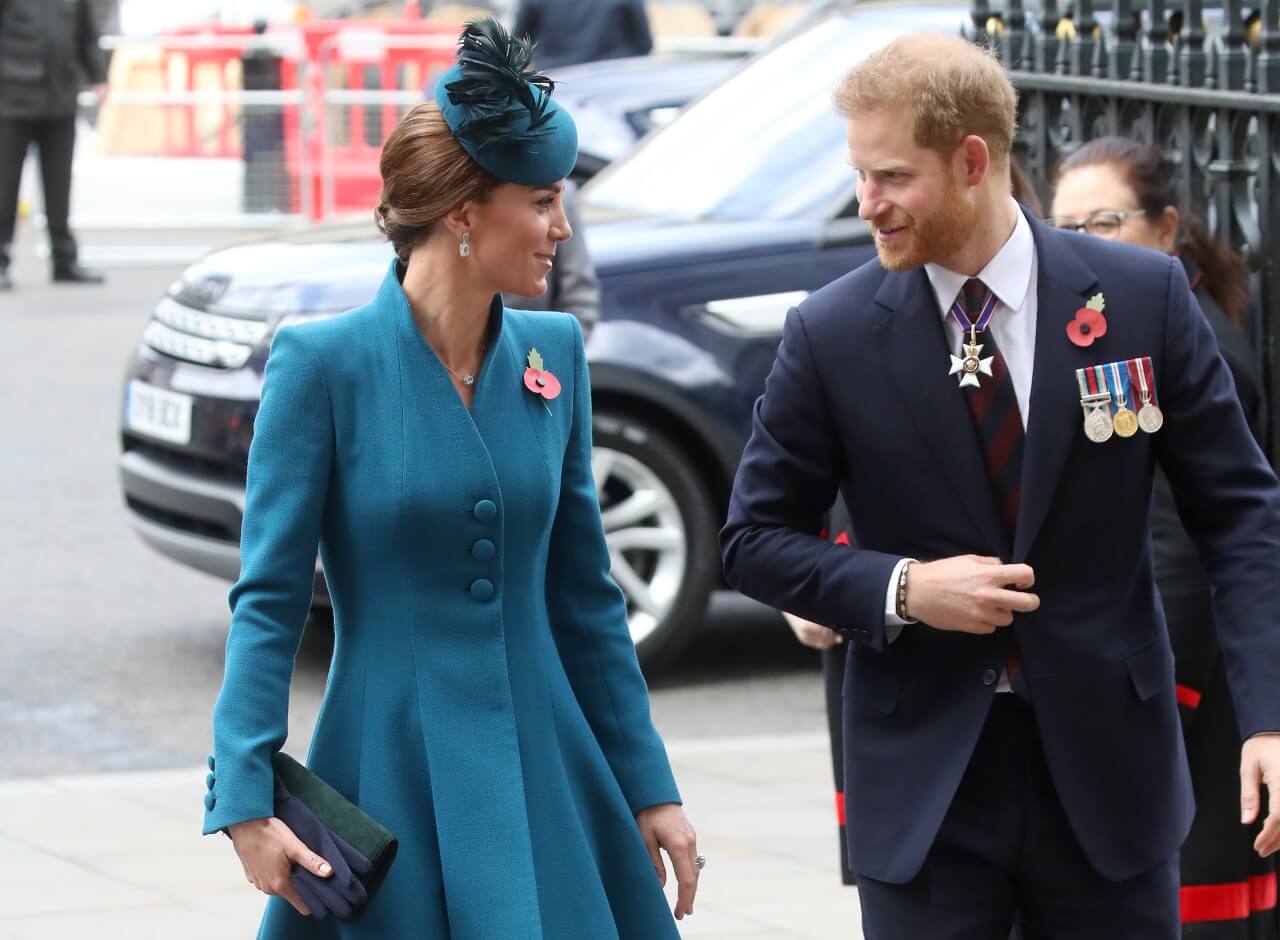 Kate Middleton and Prince Harry walk together during a royal engagement. 