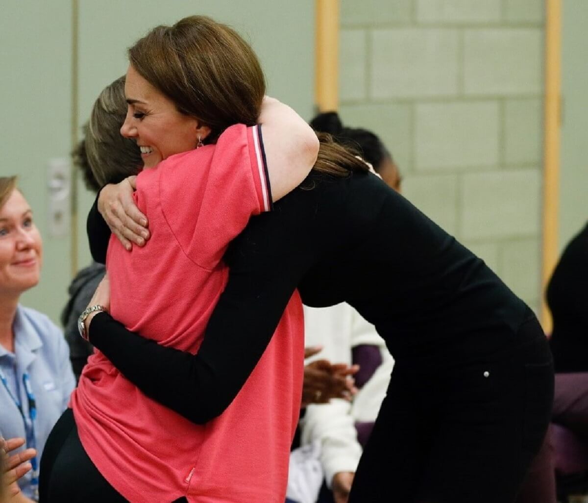 Kate Middleton hugs a participant as she meets new apprentices and graduates from the Coach Core Essex apprenticeship in 2018