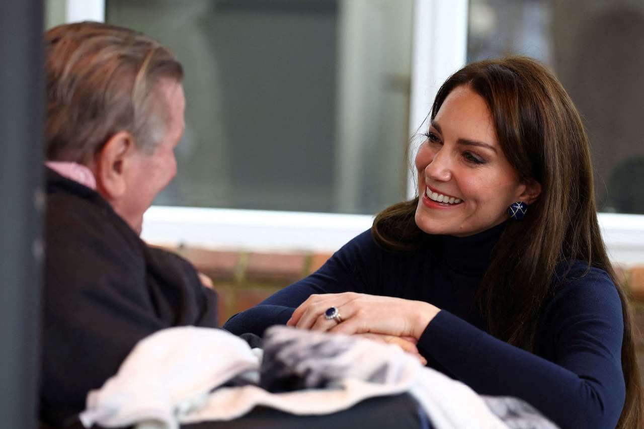 Kate Middleton, Princess of Wales (R) laughs with a resident during a visit of the Oxford House Nursing Home in Slough, on February 21, 2023.