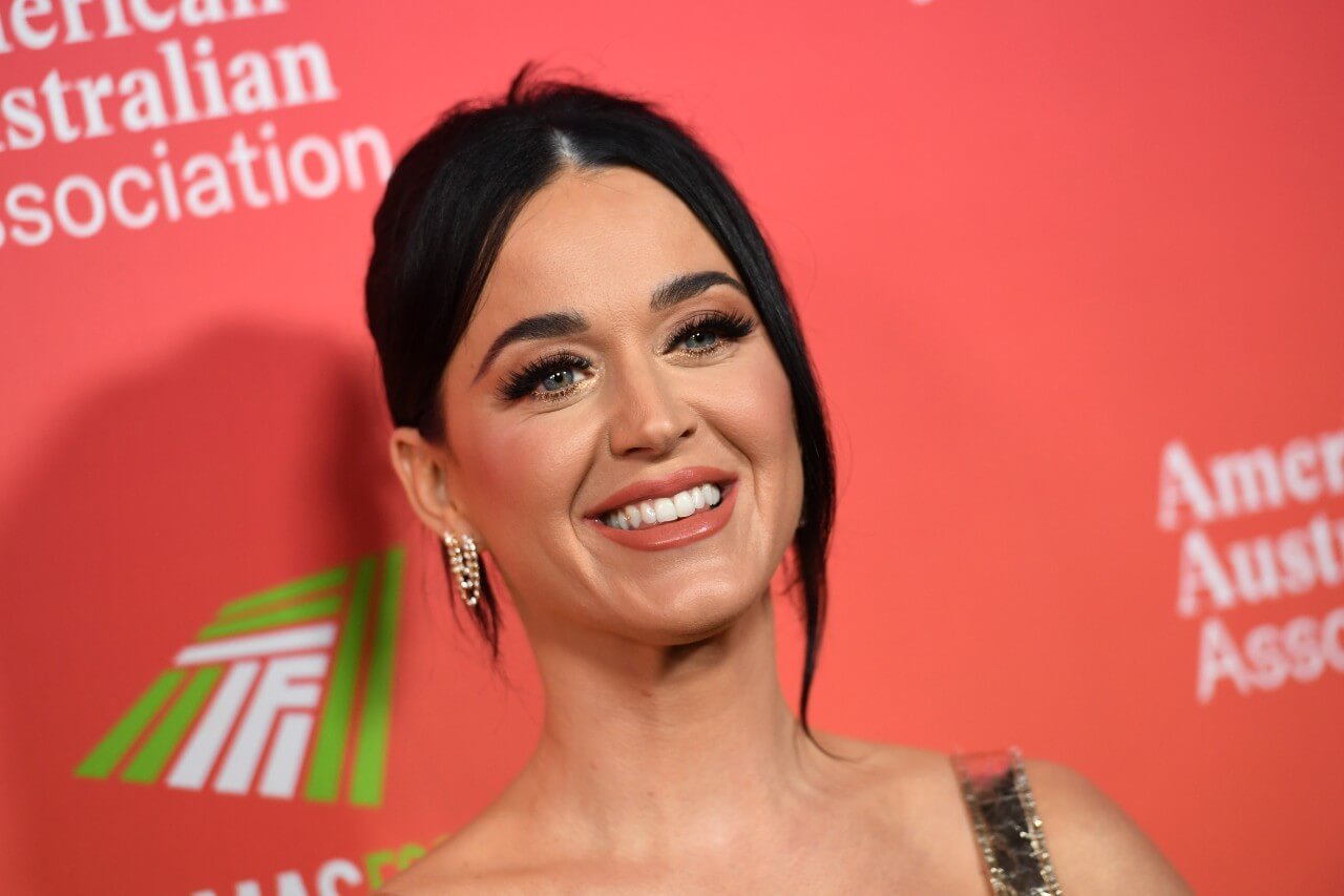 Katy Perry smiles and poses during a media event.