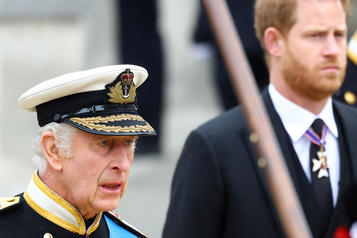 King Charles III and Prince Harry, who has reportedly received 'incentives' to attend King Charles III's coronation, look on