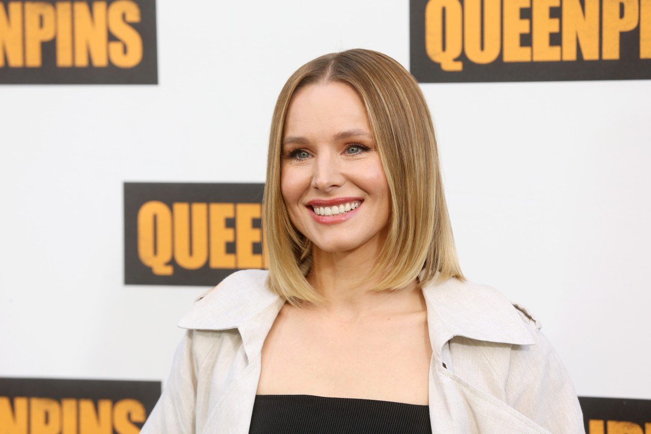 Kristen Bell poses and smiles at an event.