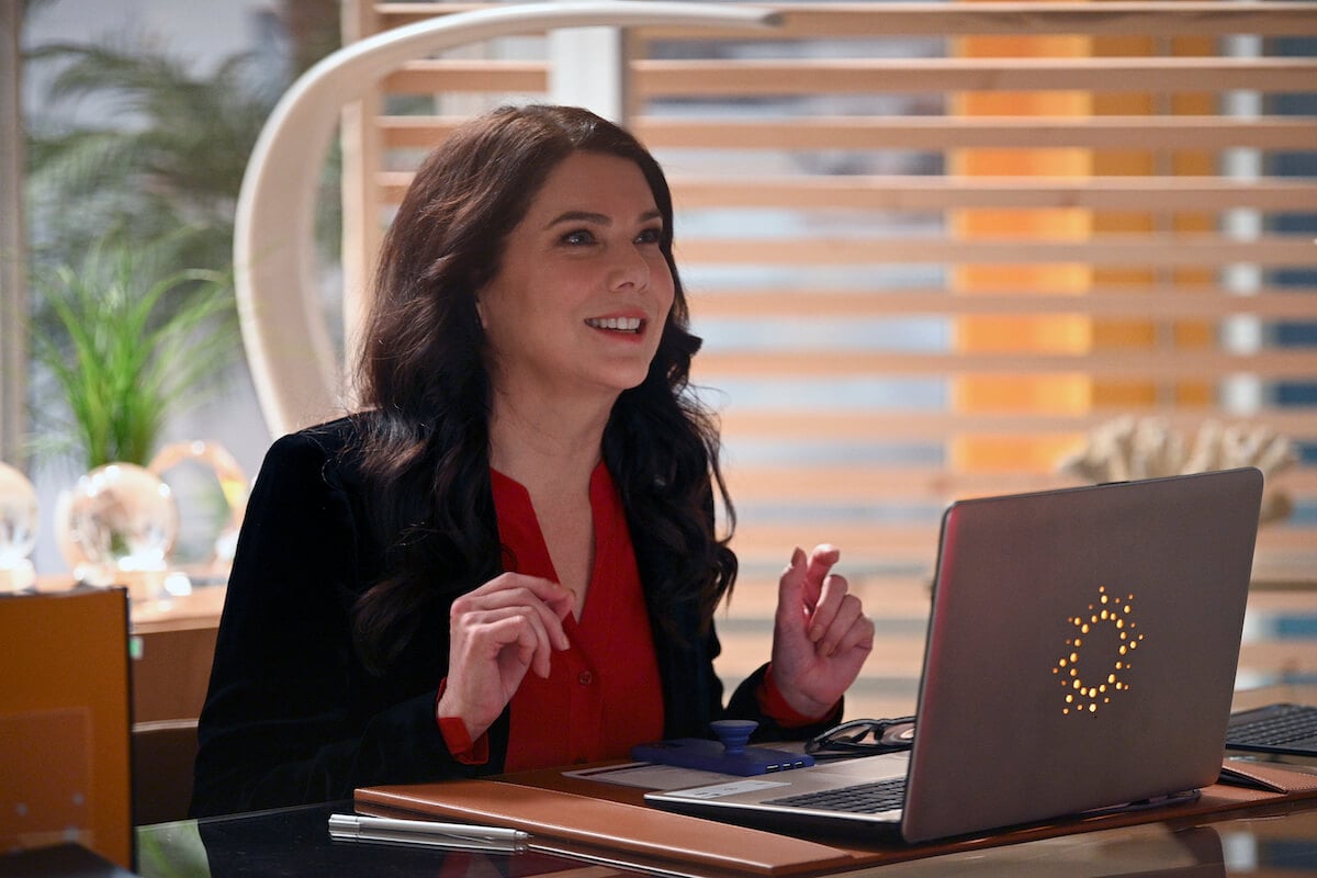 Lauren Graham sitting at a desk in front of a laptop