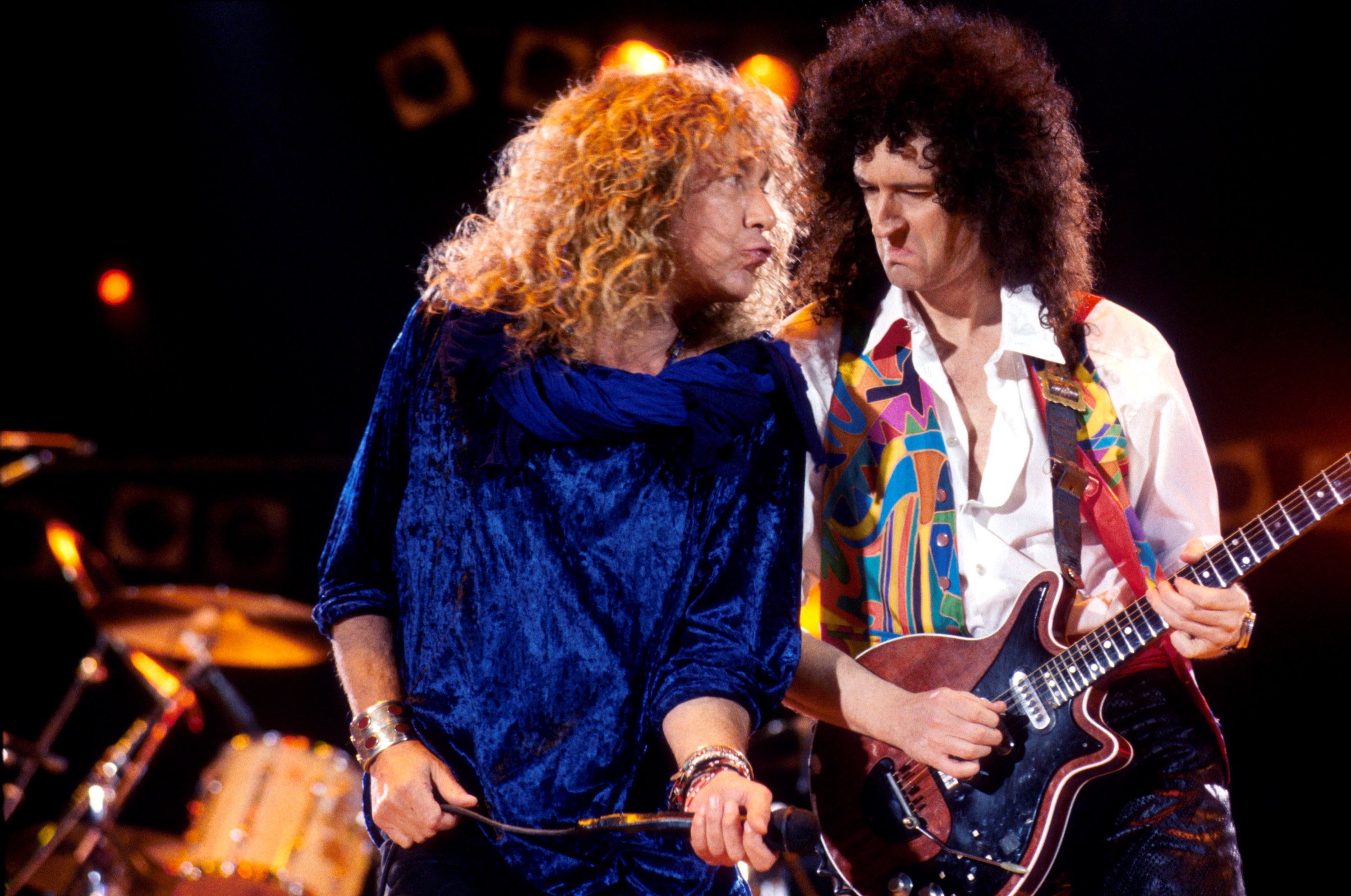 Robert Plant of Led Zeppelin performs on stage with Brian May of Queen at the Freddie Mercury Tribute Concert in 1992