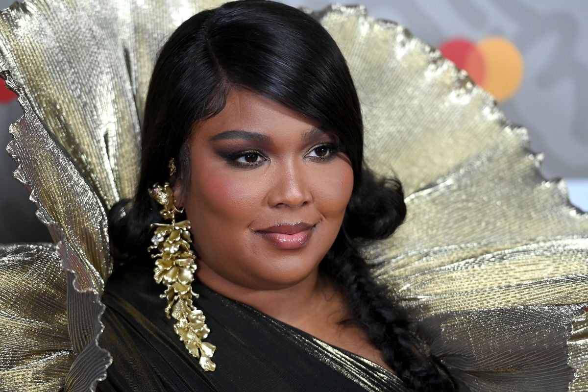 Lizzo poses for pictures on the red carpet.