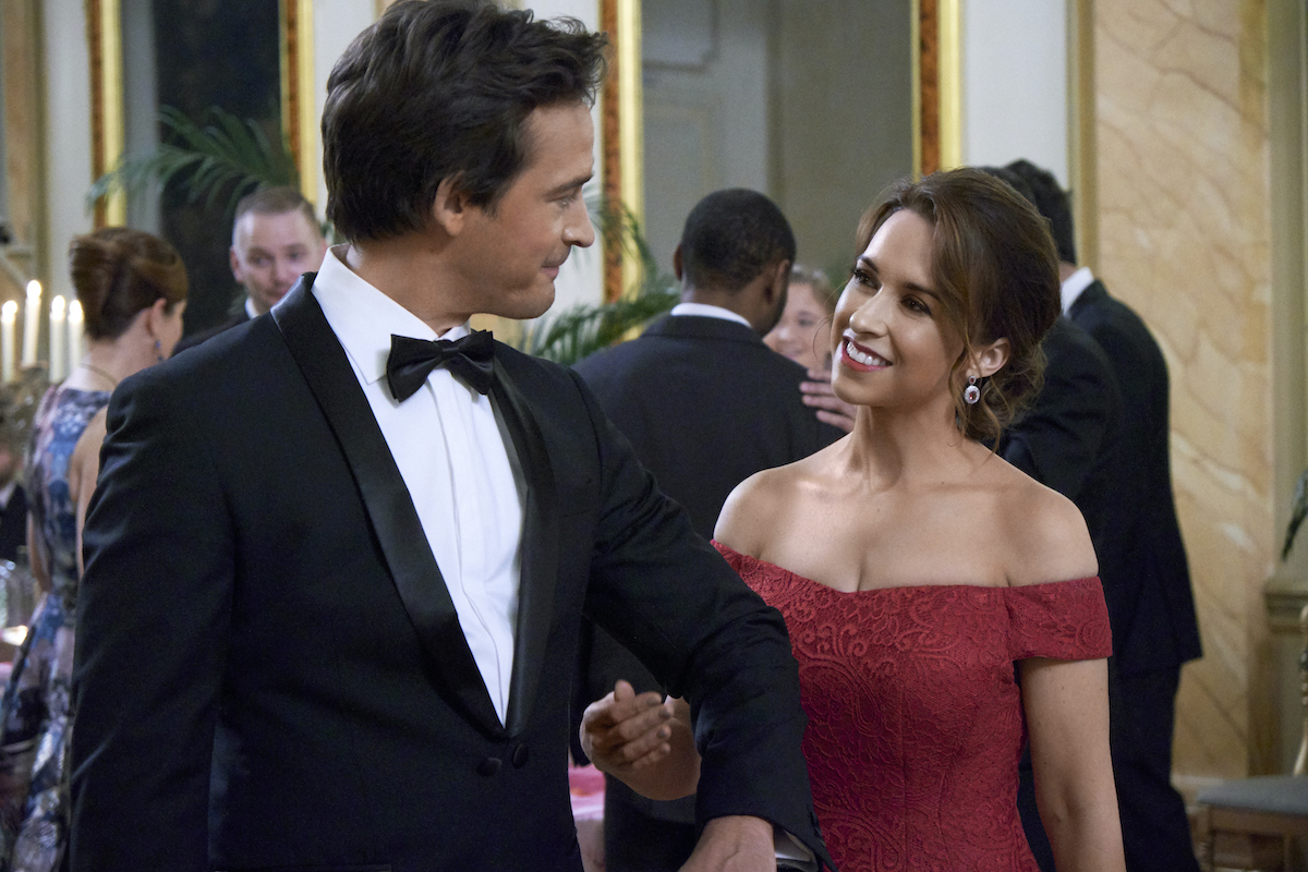 Lacey Chabert smiling at Will Kemp in the romantic Valentine's Day movie 'Love, Romance, and Chocolate' from Hallmark Channel