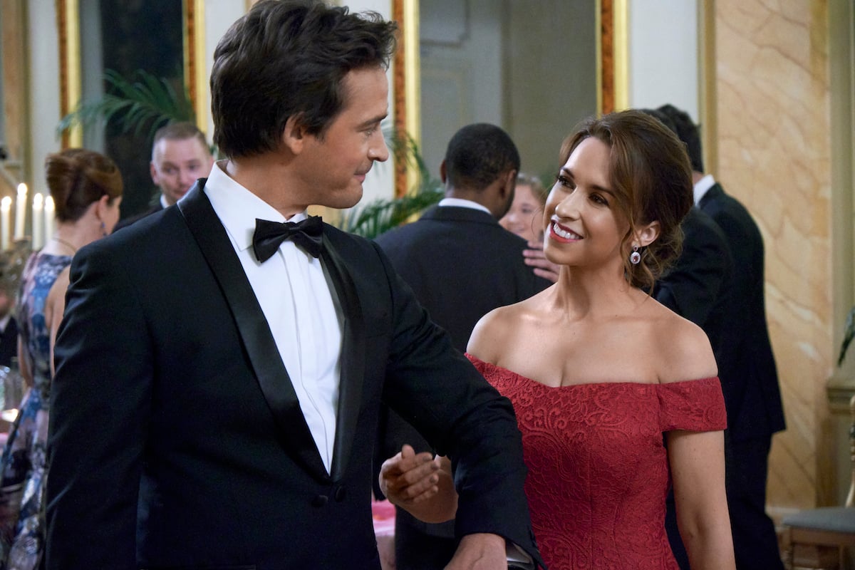 Lacey Chabert smiling at Will Kemp in the romantic Valentine's Day movie 'Love, Romance, and Chocolate' from Hallmark Channel