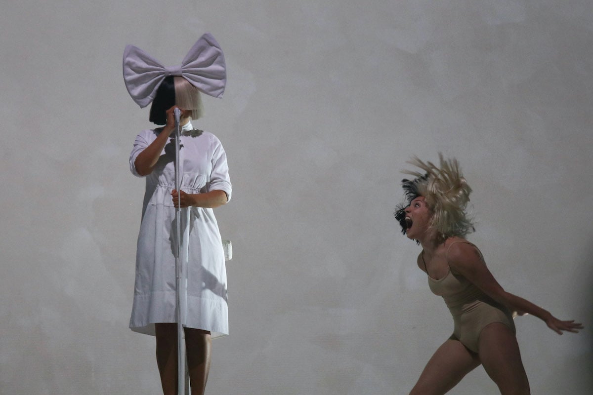 Chandelier singer Sia and Maddie Ziegler perform music and choreography on stage