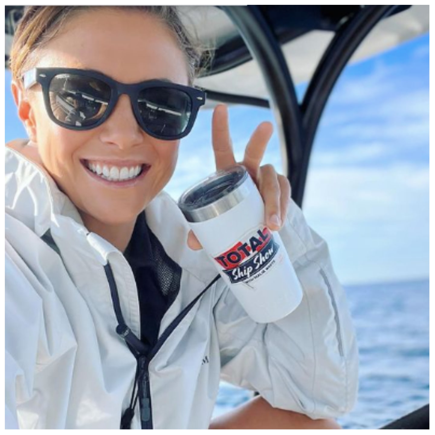 Malia White from 'Below Deck Med' gives the peace sign while wearing sunglasses and holding a tumbler