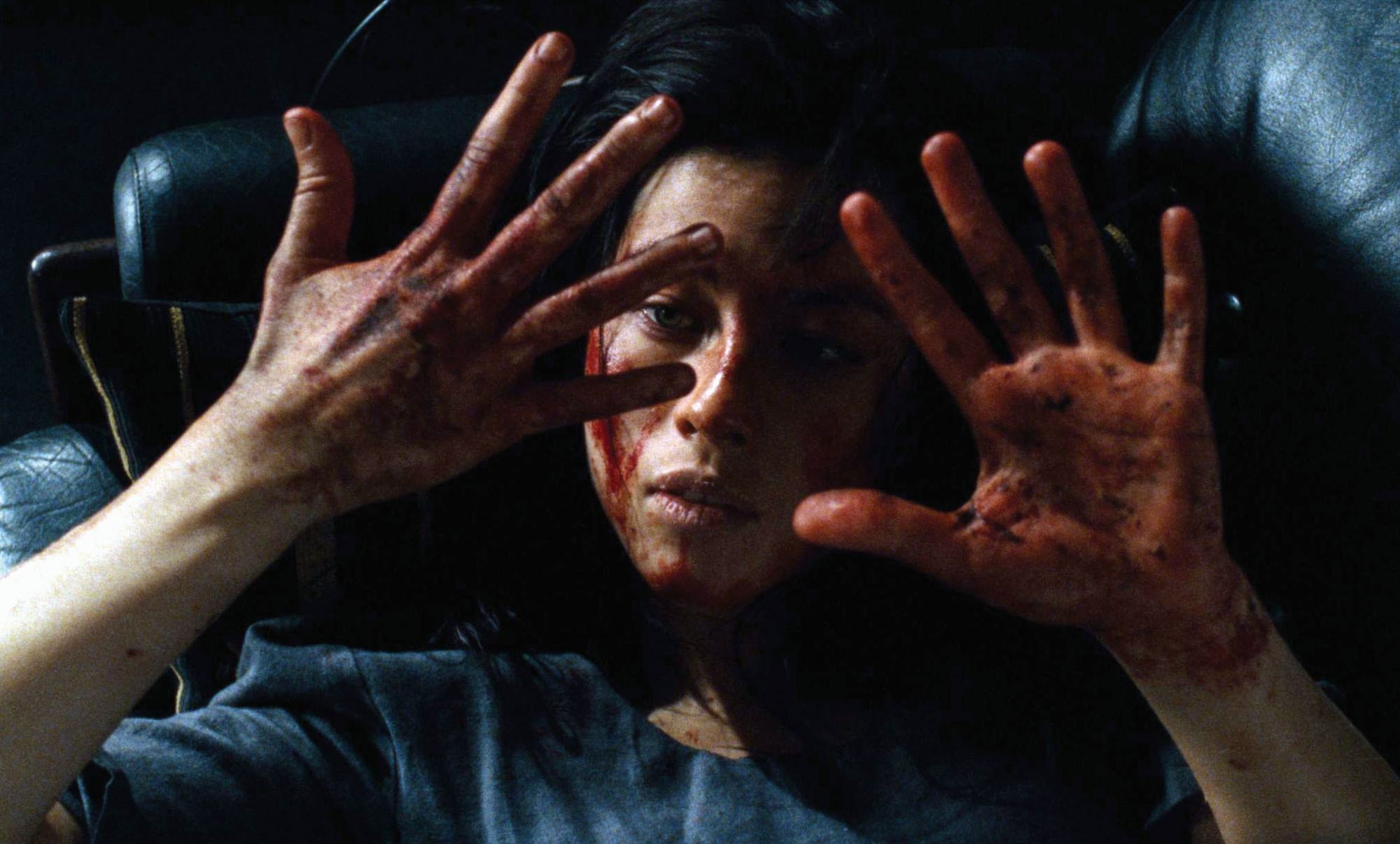 'Martyrs' Mylène Jampanoï as Lucie looking at her hands, which are covered in dried blood