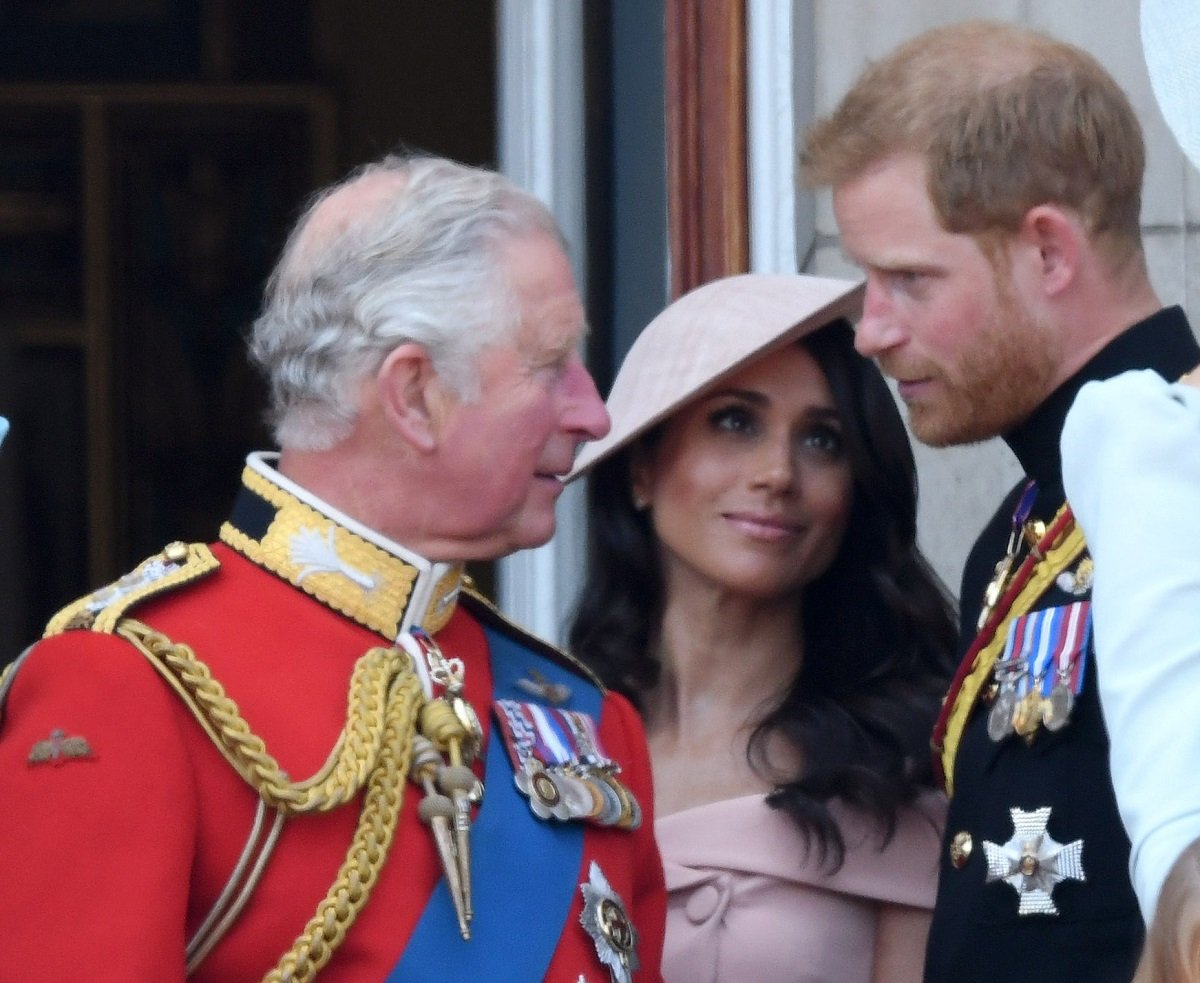 Now-King Charles III with Meghan Markle and Prince Harry, whose children likely won't attend the coronation, standing on the balcony of Buckingham Palace during Trooping The Colour 2018