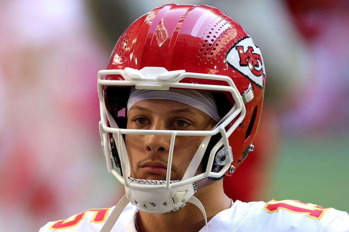 Kansas City Chiefs quarterback Patrick Mahomes wearing his helmet and uniform on the football field.