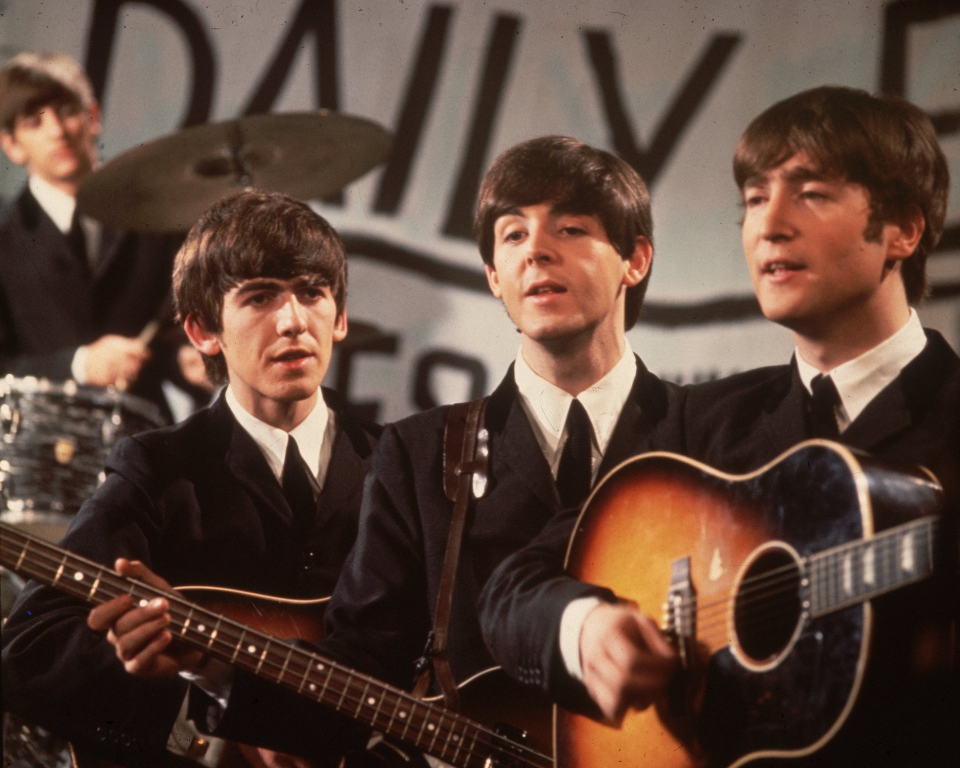 A group shot of the Beatles, Ringo Starr (in the background), George Harrison, Paul McCartney and John Lennon, pictured during a performance on Granada TV's Late Scene Extra television show filmed in Manchester, England