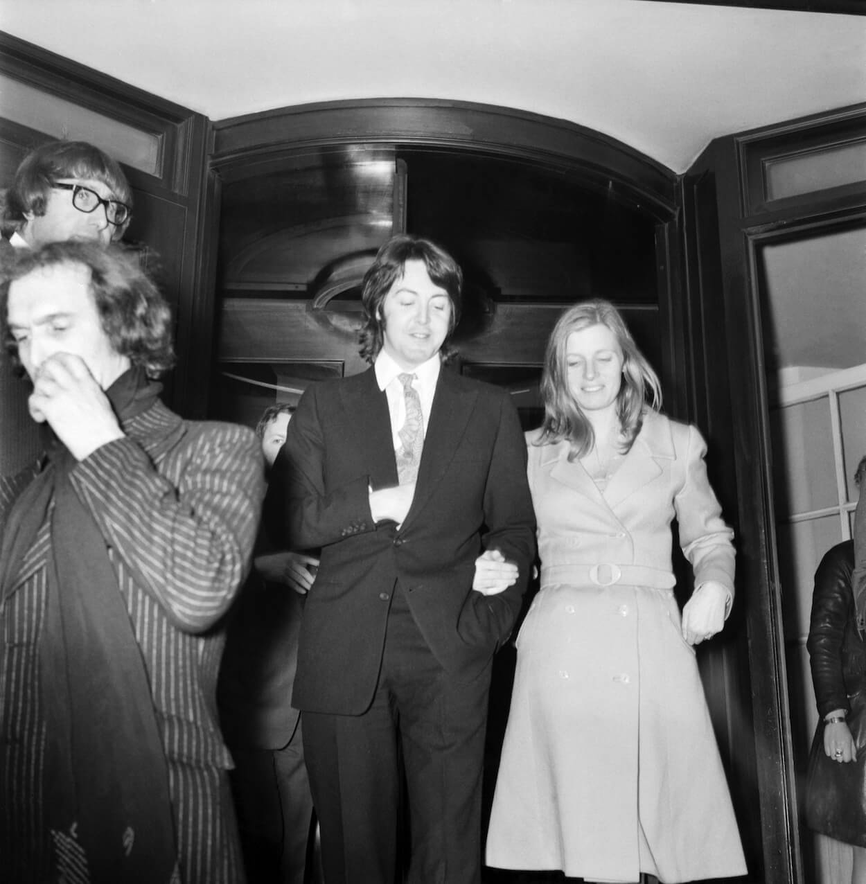 Paul McCartney (center left) and Linda Eastman leave the Ritz Hotel after celebrating their wedding on March 12, 1969.